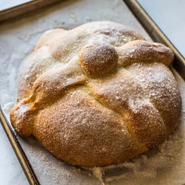 Pan de Muerto (or Day of the Dead Bread) on a baking sheet ready to eat.