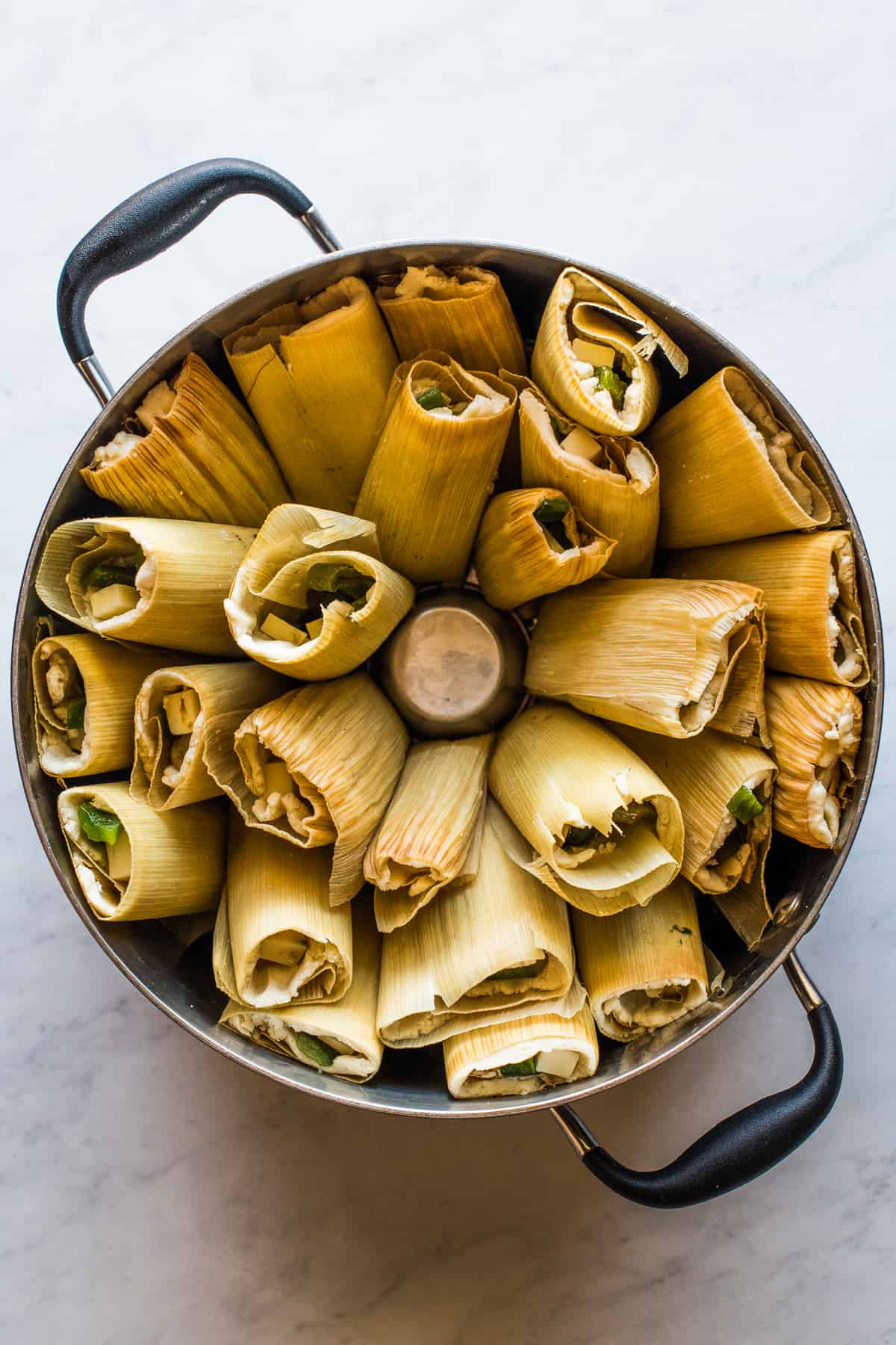 Tamales de rajas in a steamer pot ready to steam.