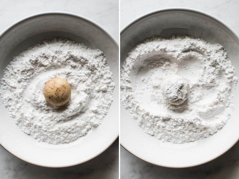 Baked Mexican Wedding Cookies being rolled in powdered sugar.