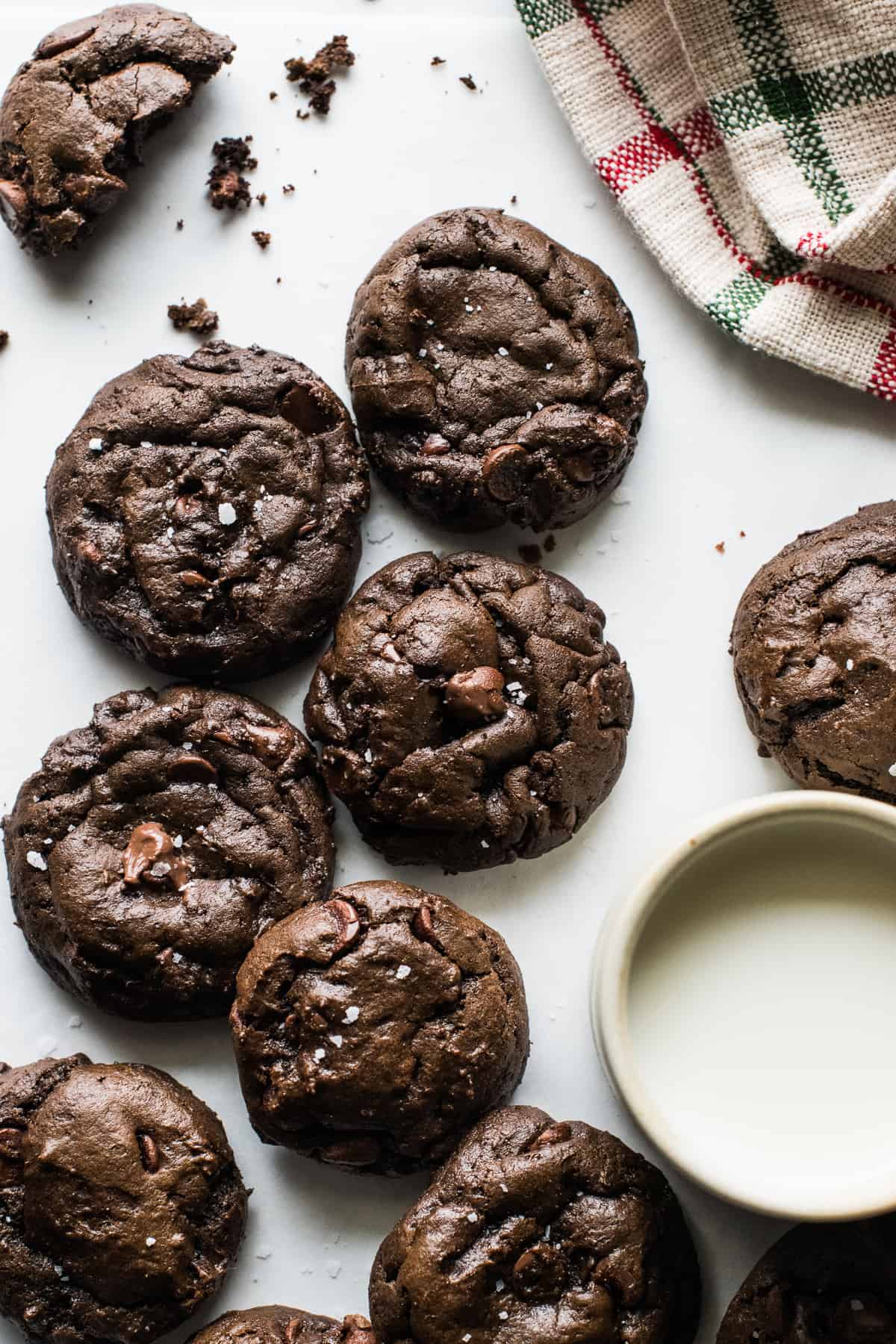 Mexican Hot Chocolate Cookies on a table with a glass of milk.