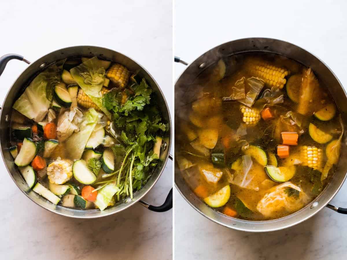 A large soup pot filled with zucchini, carrots, cabbage, cilantro and more for Caldo de Res.