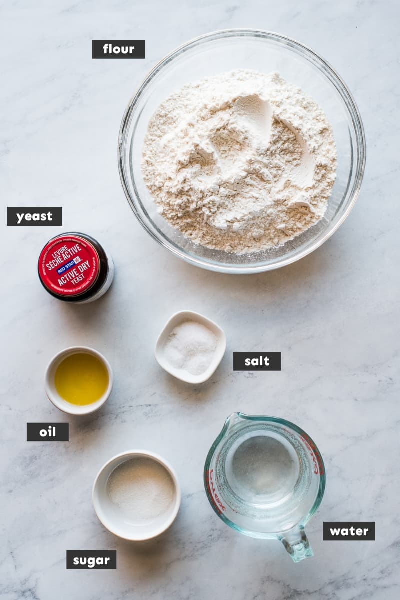 Ingredients in bolillo bread on a table.