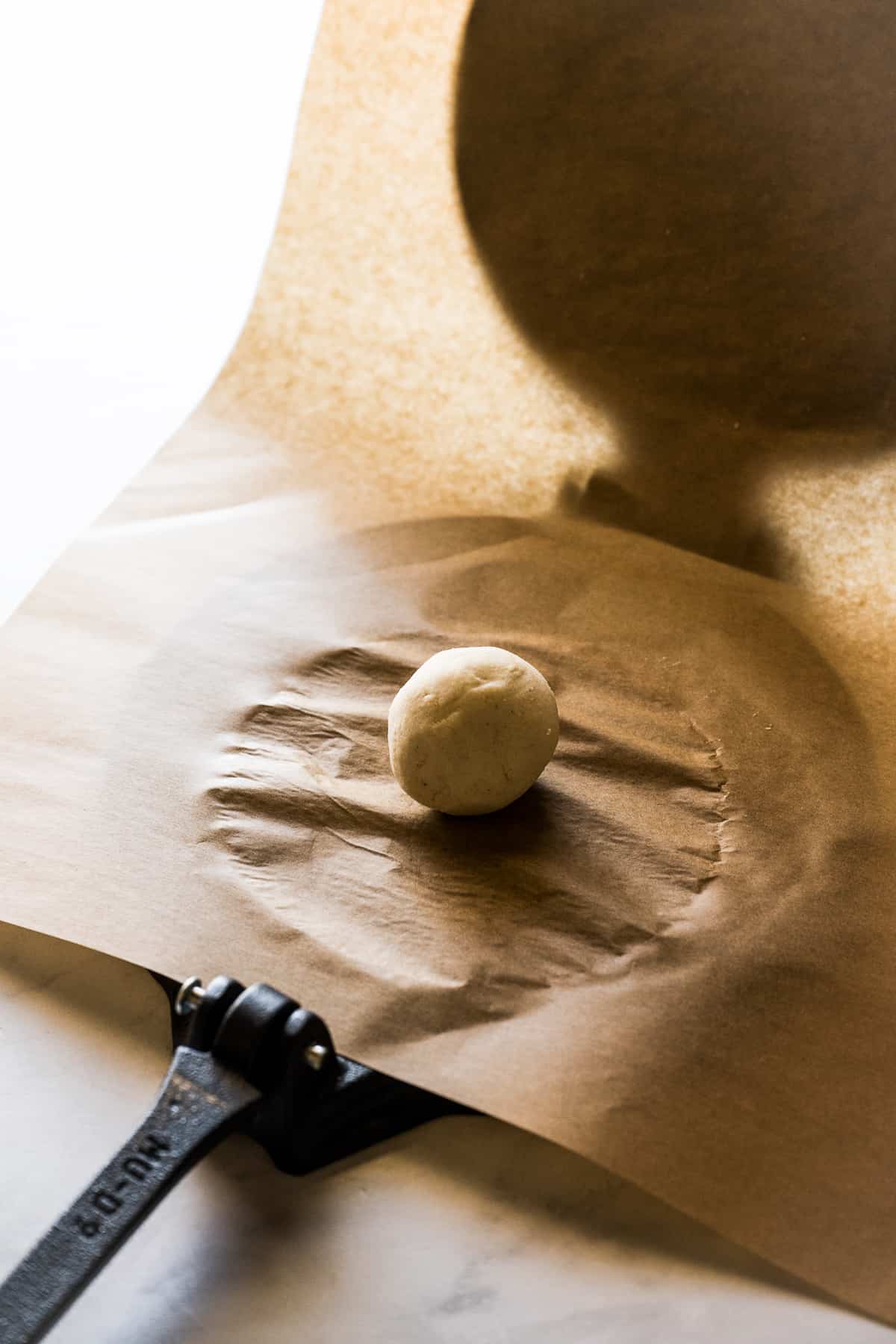 A ball of masa harina on a tortilla press.
