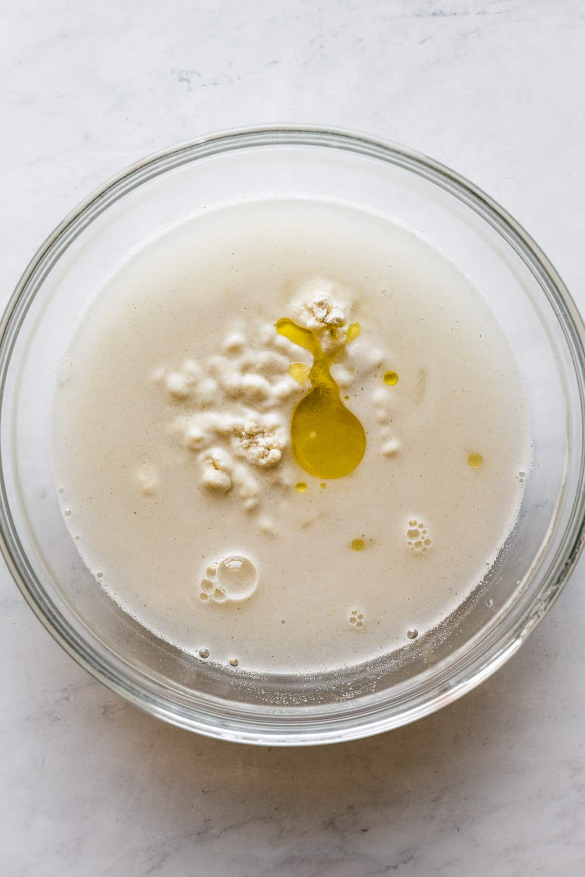 Oil, water, salt, and masa harina in a bowl.