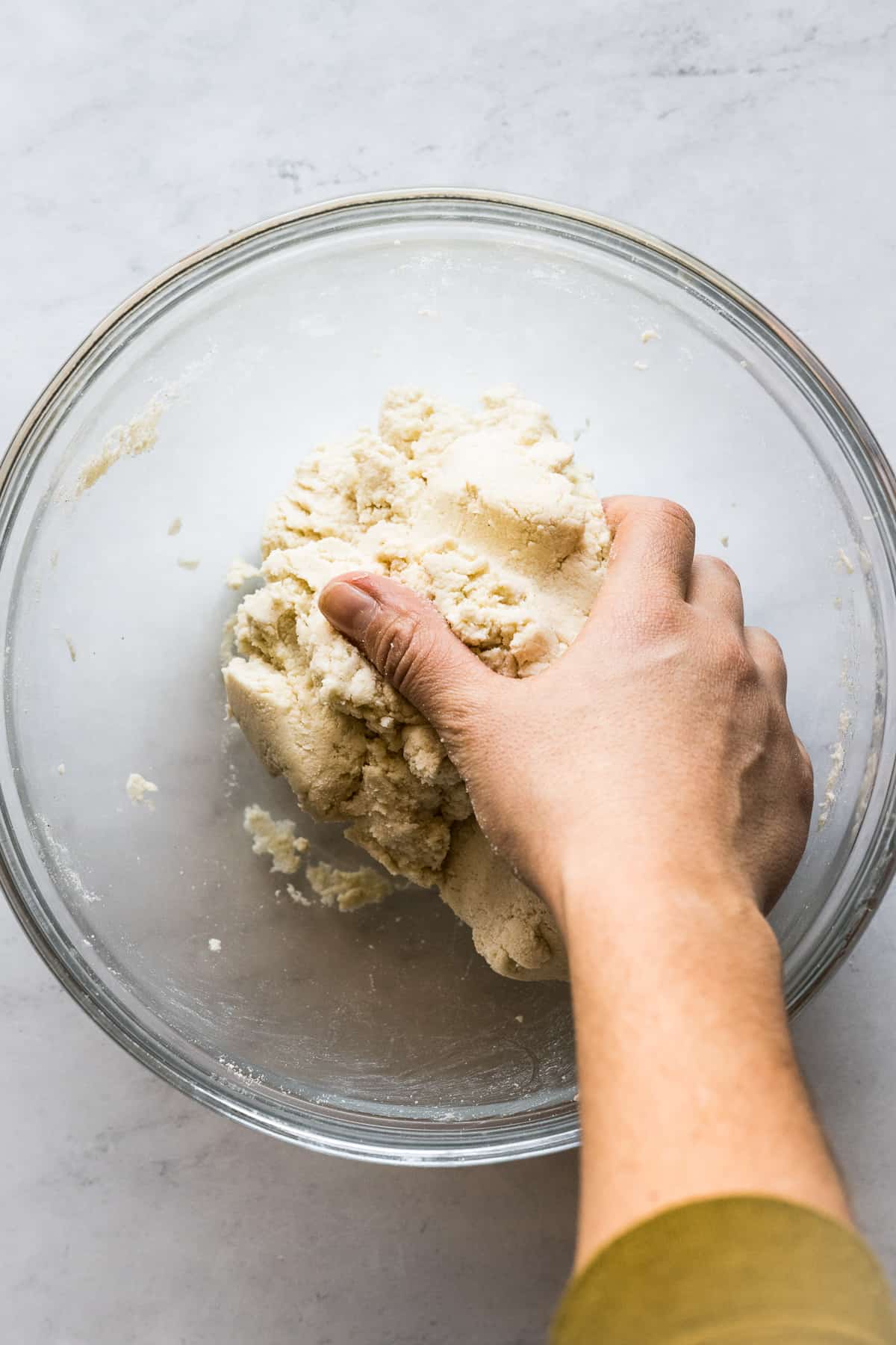 Masa harina being kneaded by hand to make corn tortillas.