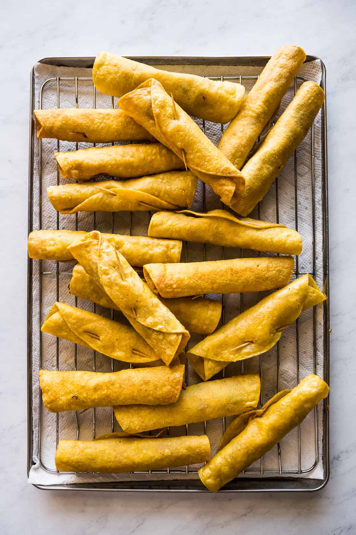 Chicken flautas on a sheet pan.