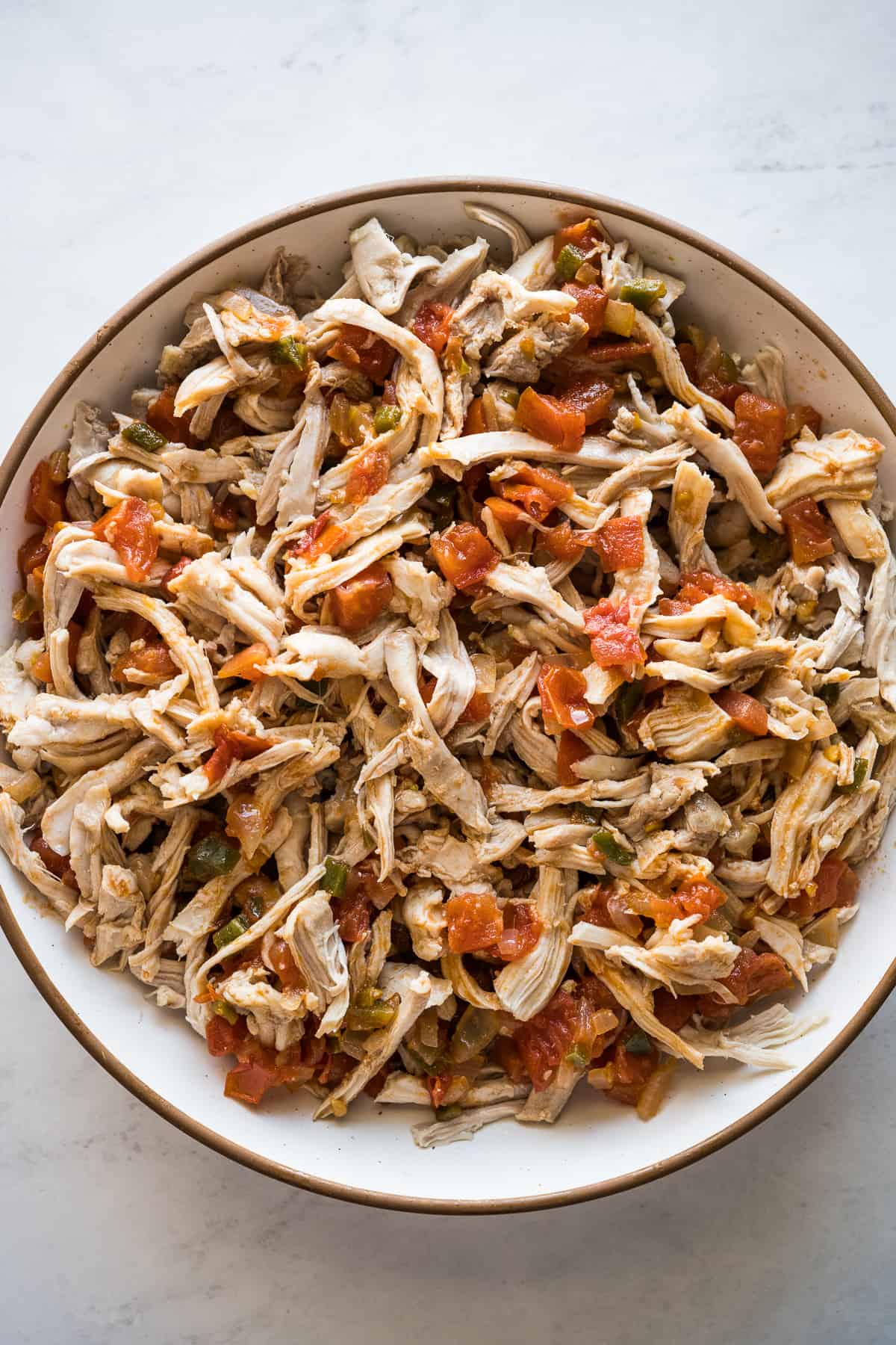 Shredded chicken filling for flautas in a bowl.