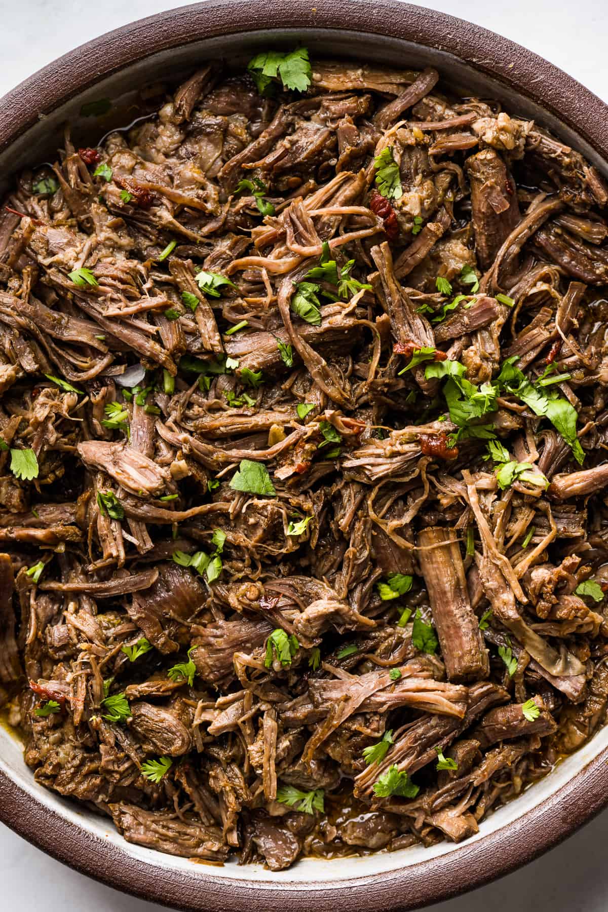 Shredded barbacoa beef in a serving bowl ready to eat.
