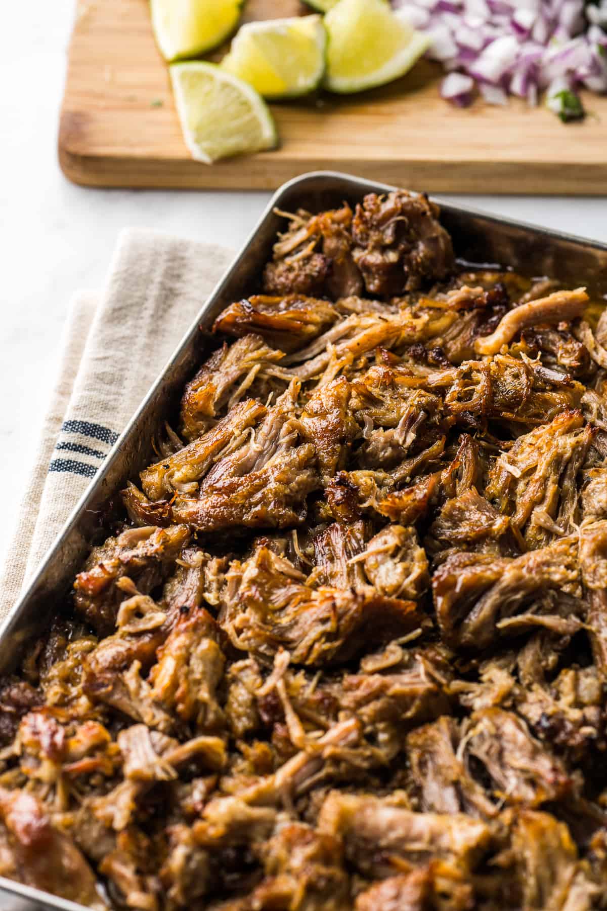 Crispy and juicy carnitas on a baking sheet ready to be served.