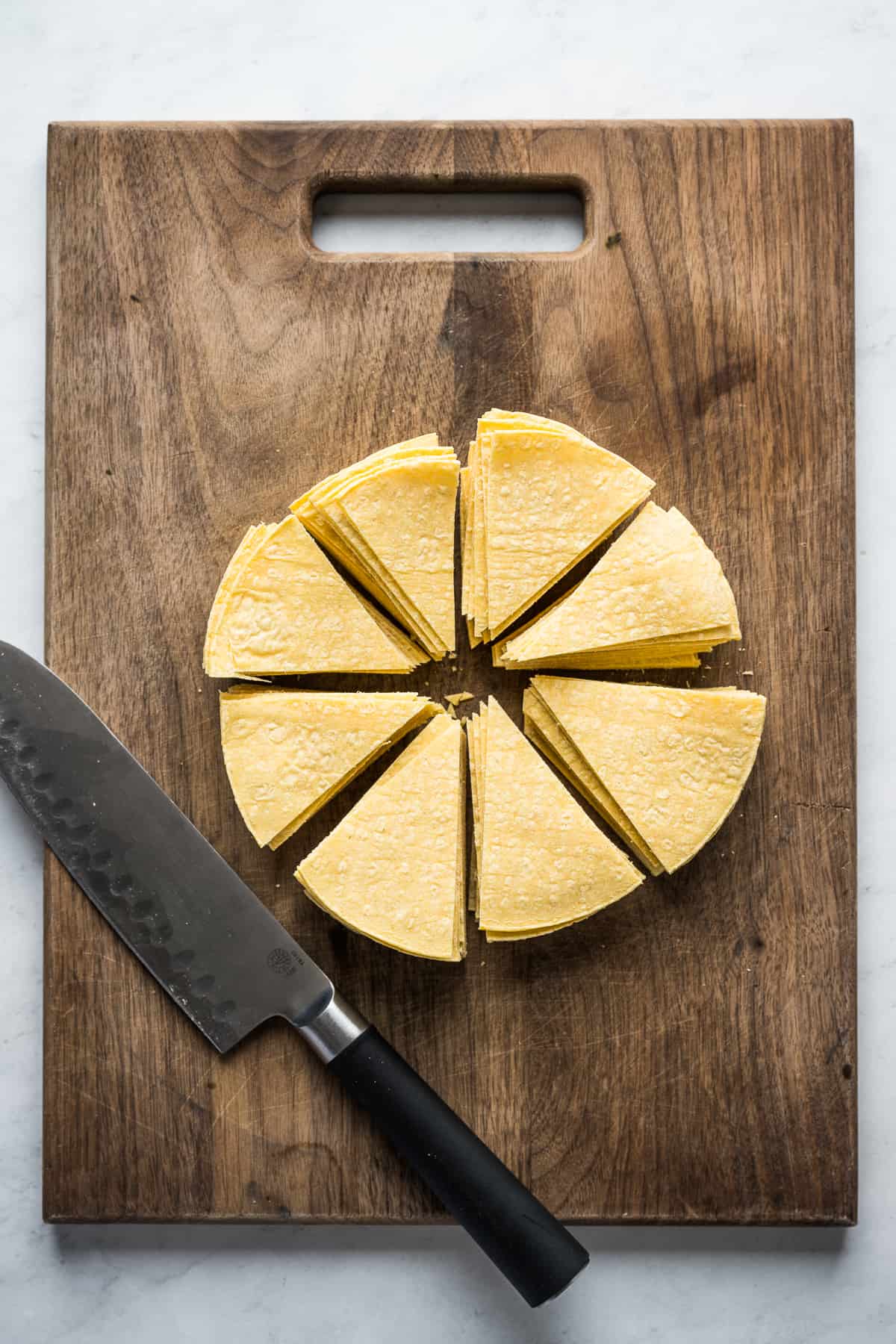 Corn tortillas cut into wedges to make into chips.