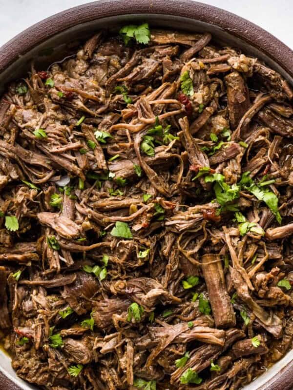 Shredded barbacoa beef in a serving bowl ready to eat.