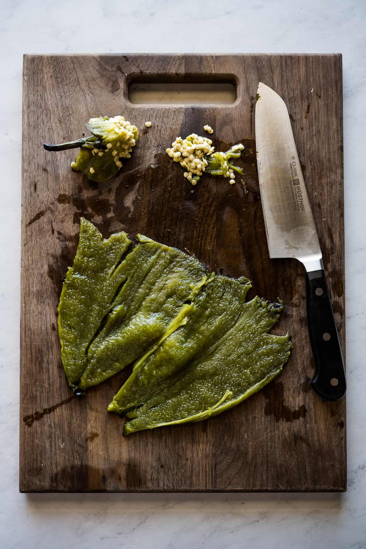 A roasted poblano pepper peeled open with the seeds removed.