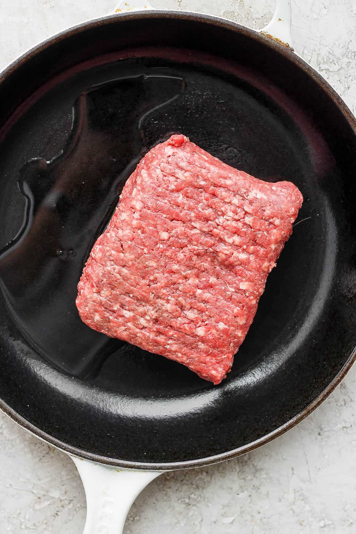 Ground beef in a skillet.