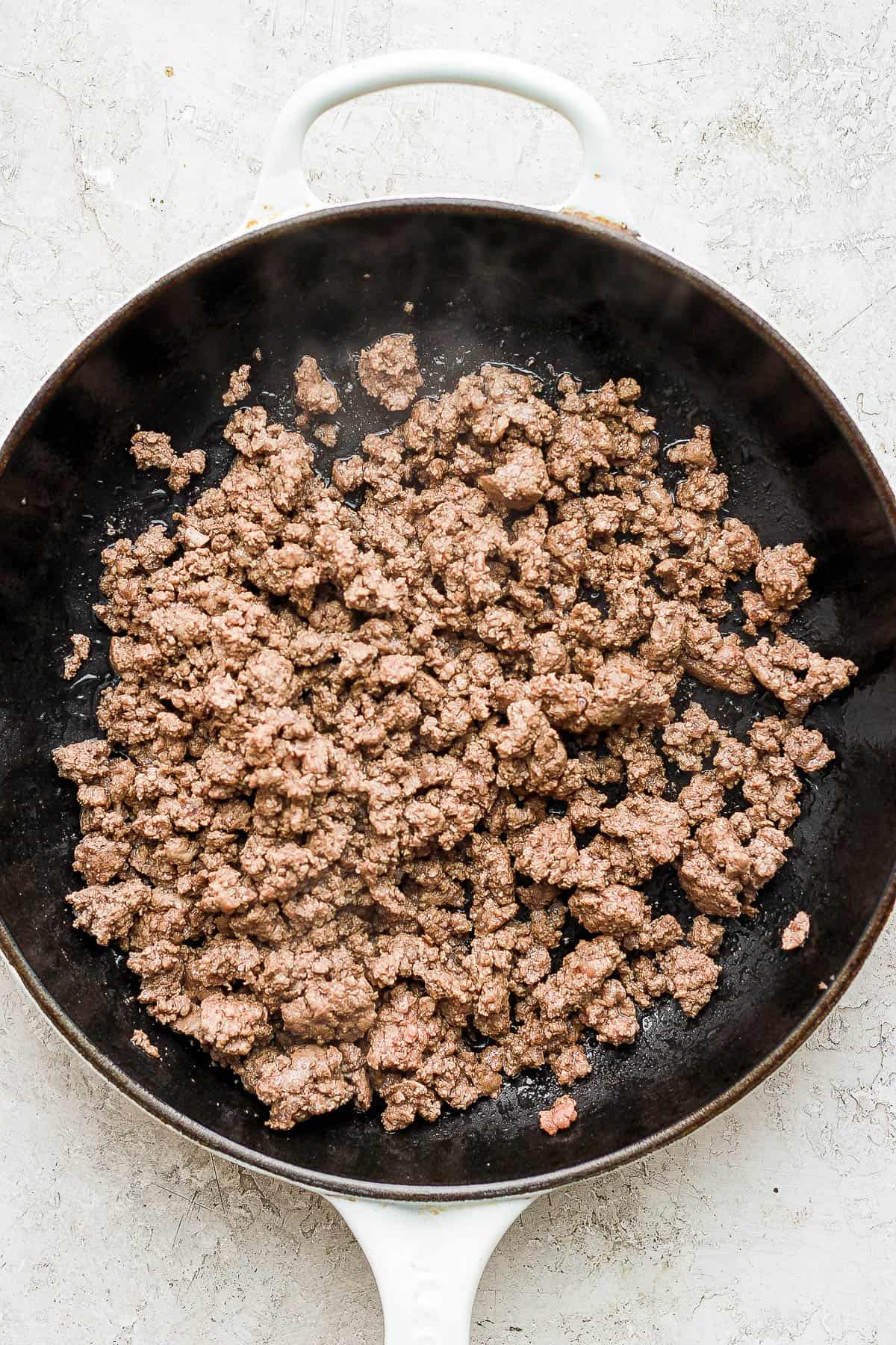 Cooked ground beef in a skillet.