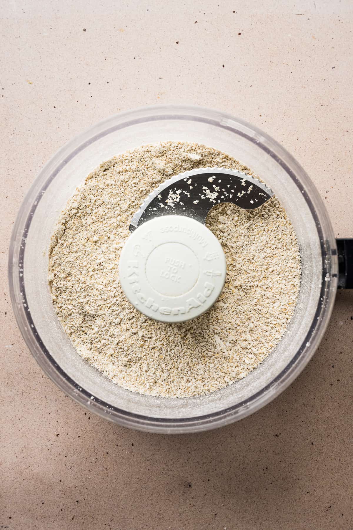 A food processor with ground oats.