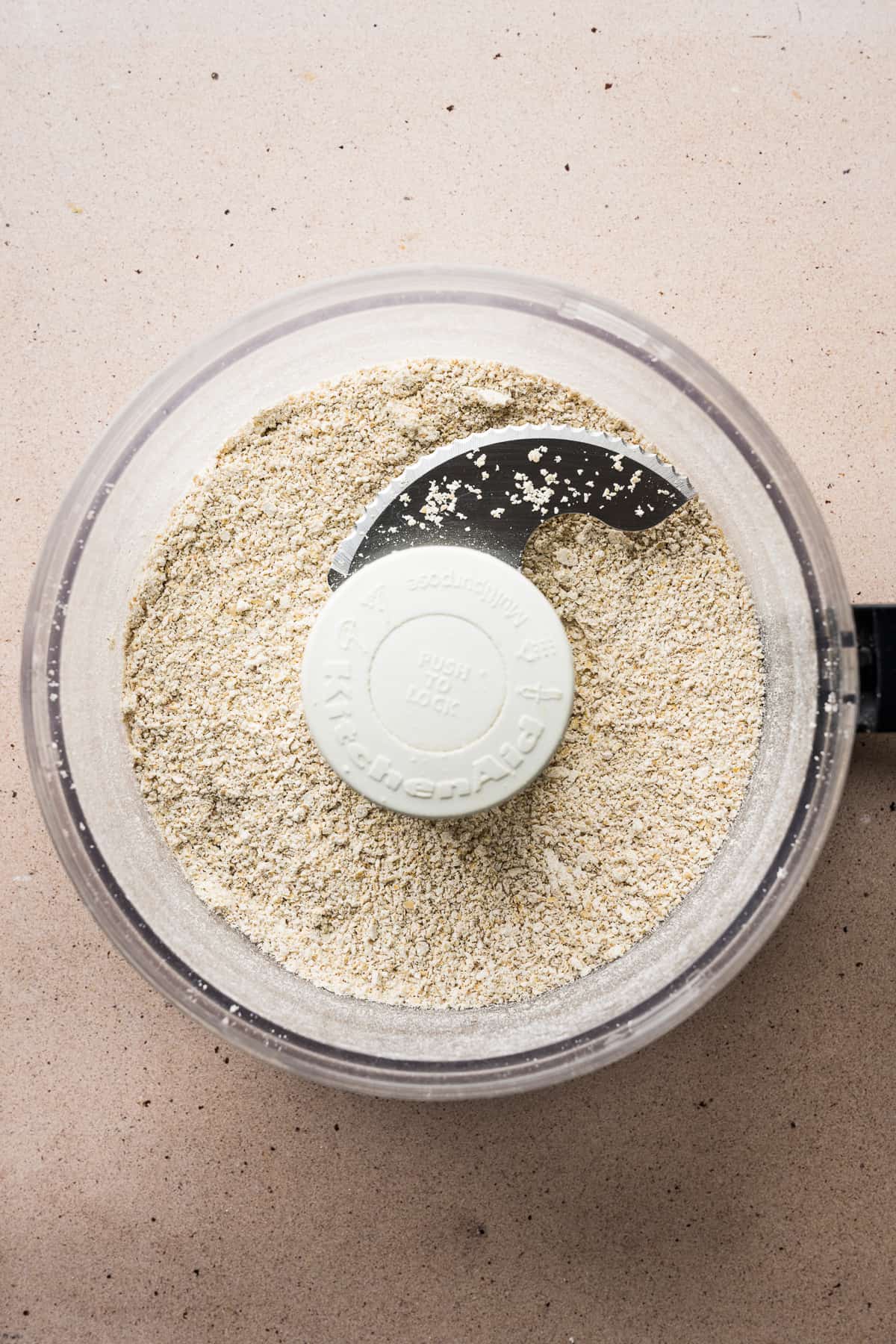 A food processor with ground oats.