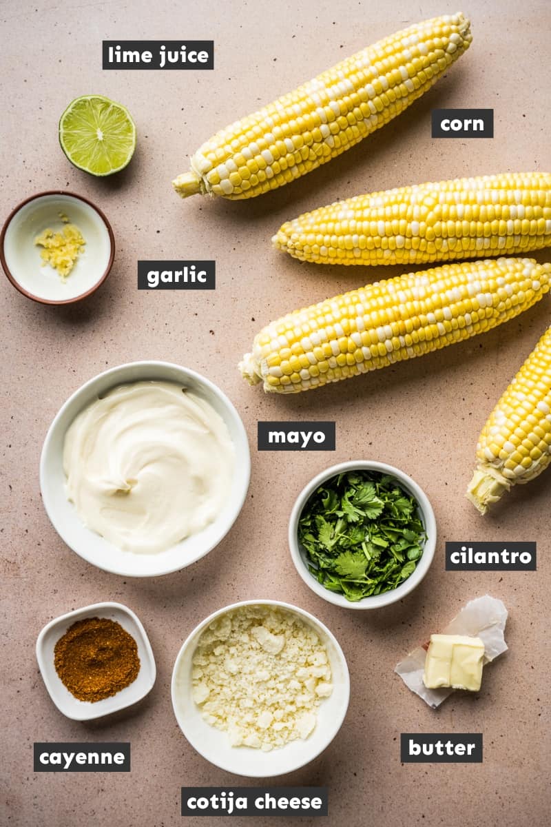 Ingredients for elote (mexican street corn) on a table.