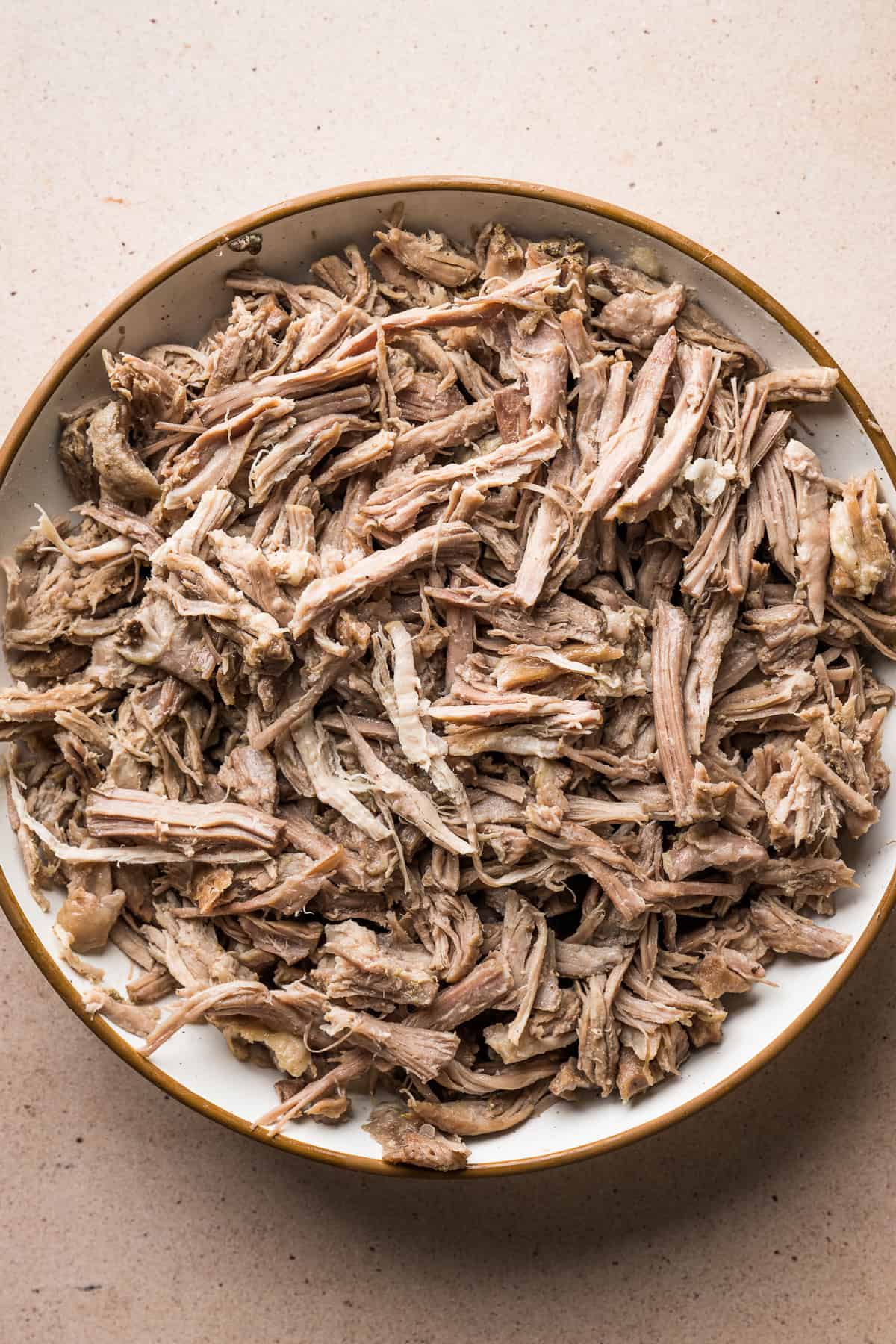 Shredded pork on a plate for pozole blanco.