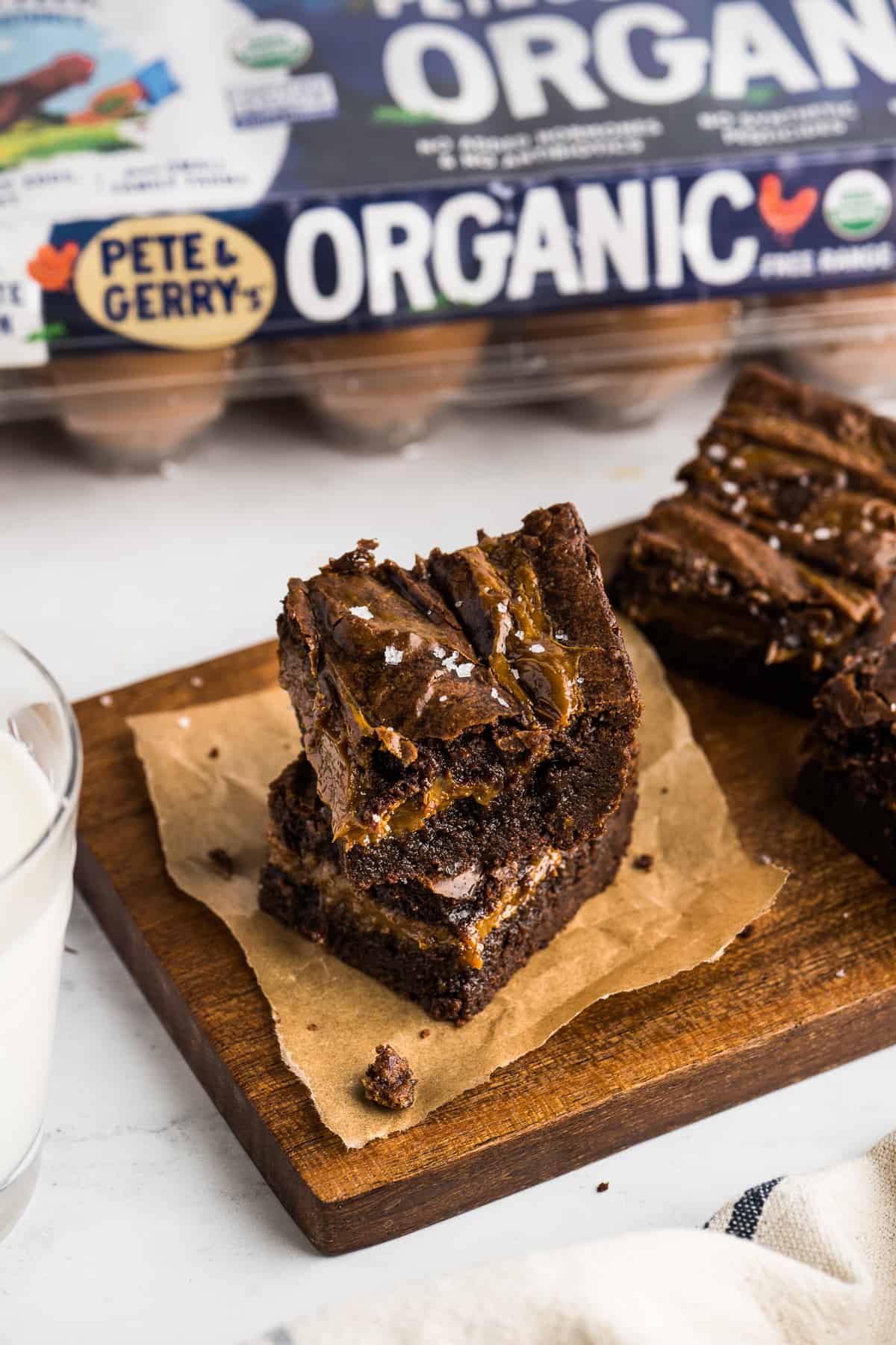 Dulce de Leche Brownies cut into squares on a table served with a glass of milk