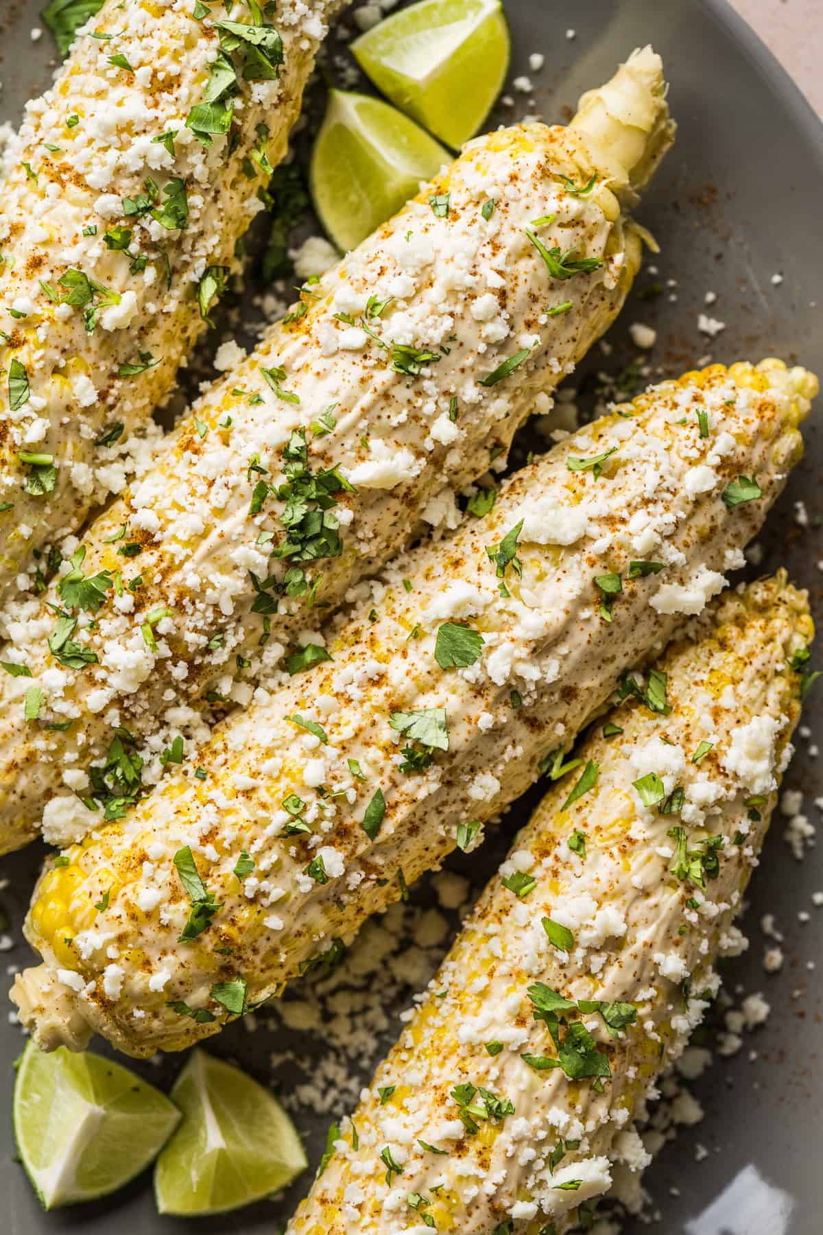 Elote (Mexican Street Corn) on a serving platter ready to be eaten.