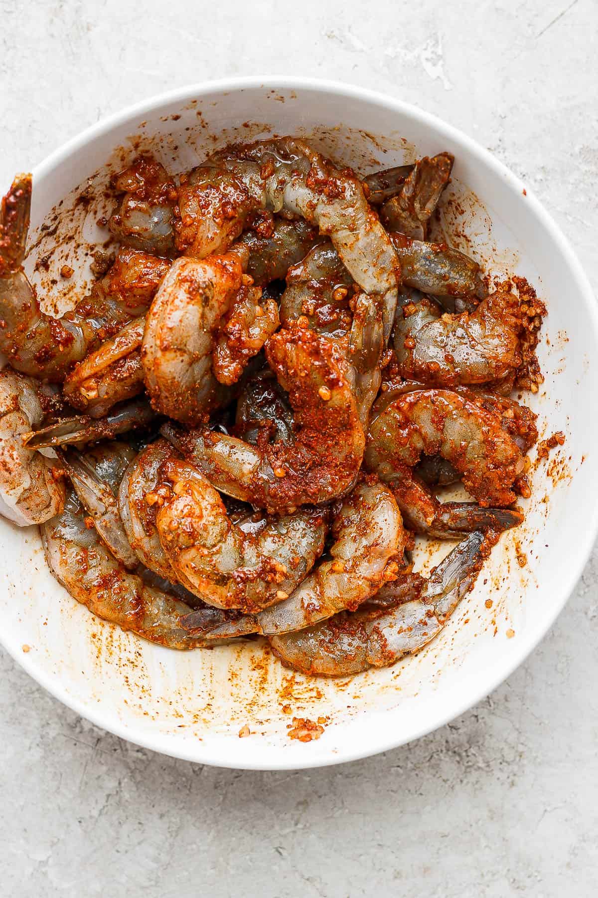 Seasoned shrimp in a bowl for making shrimp fajitas.