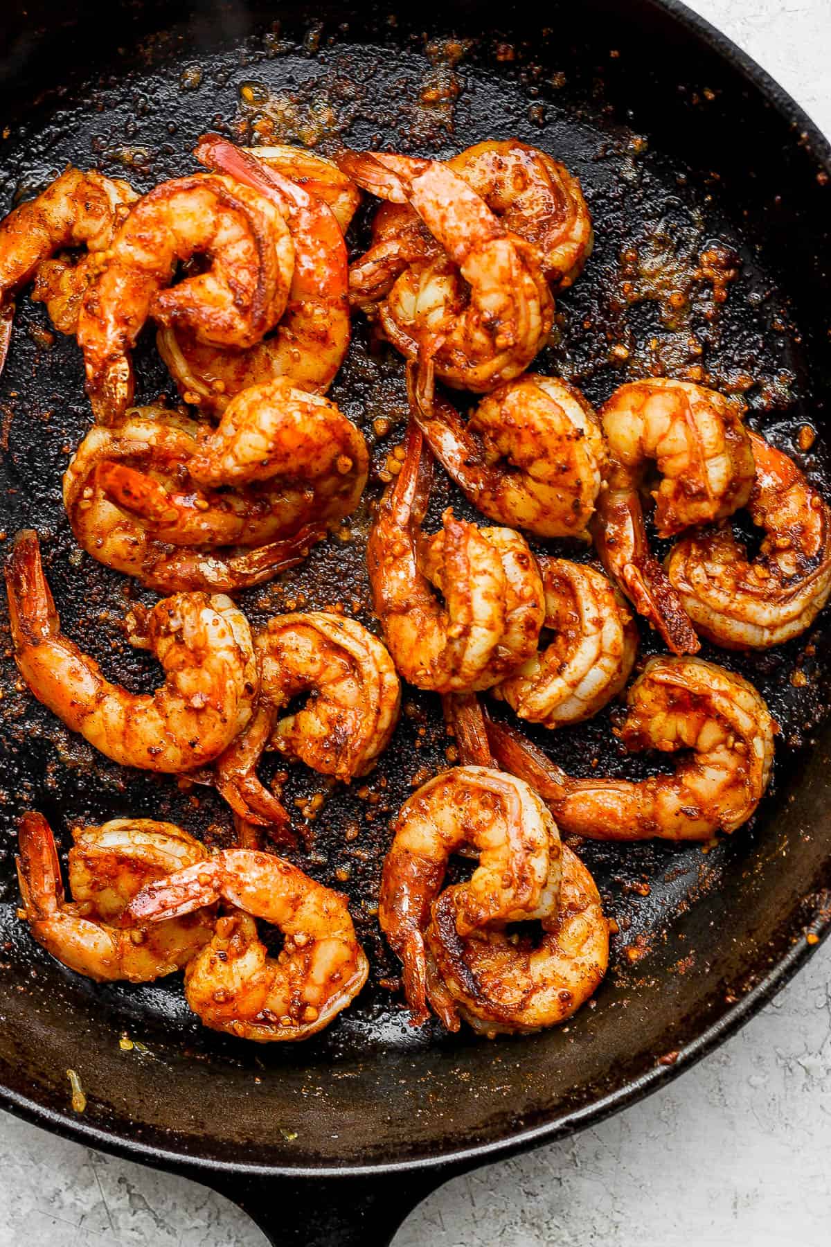 Cooked and seasoned jumbo shrimp for shrimp fajitas.