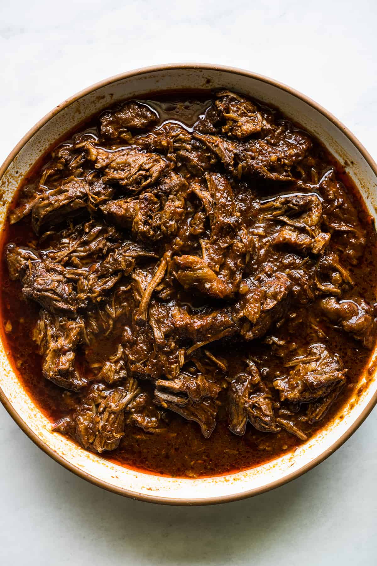 Cooked and shredded birria in a bowl.