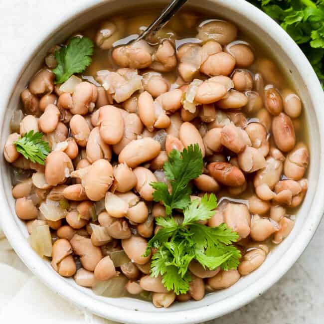 Crock pot pinto beans in a bowl.