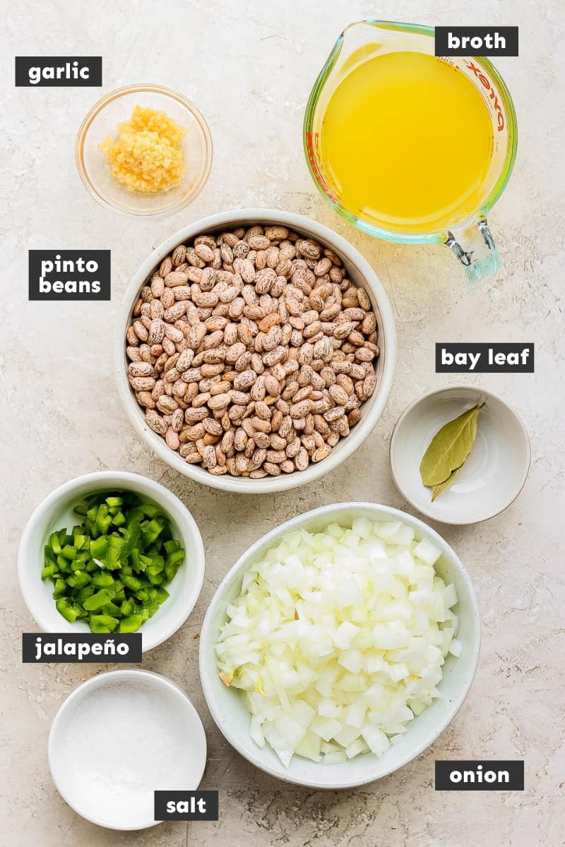 Ingredients for crock pot pinto beans on a table.