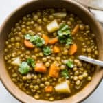 A bowl of lentejas (Mexican lentil soup) topped with cilantro.