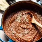 Mole sauce (mole poblano) in a pot sprinkled with sesame seeds ready to serve.