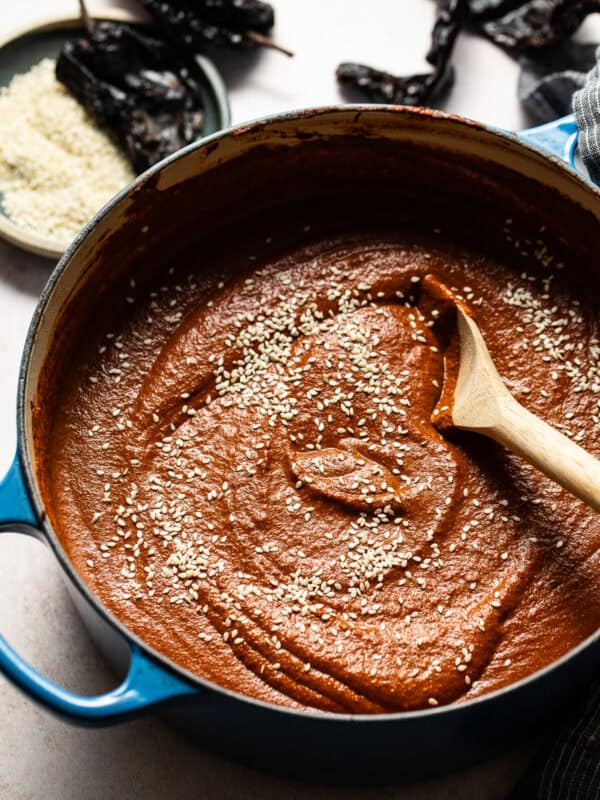 Mole sauce (mole poblano) in a pot sprinkled with sesame seeds ready to serve.