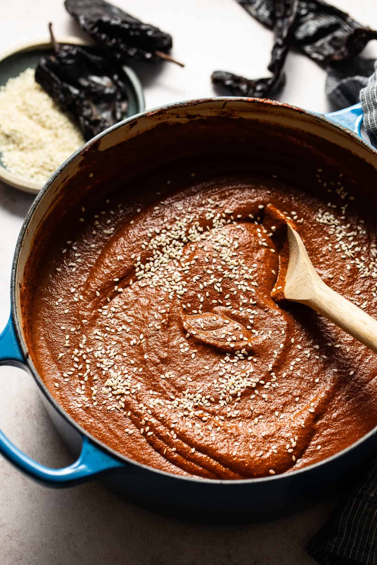 Mole sauce (mole poblano) in a pot sprinkled with sesame seeds ready to serve.