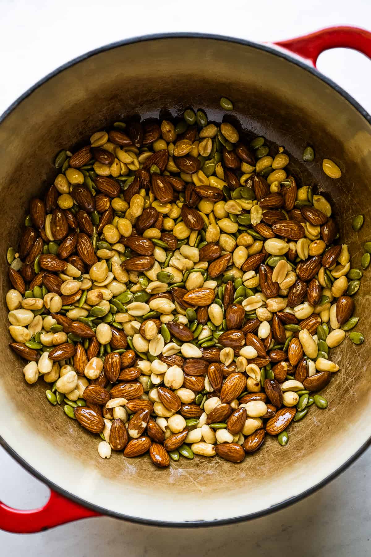 Nuts and seeds toasting and frying in pot for mole sauce.