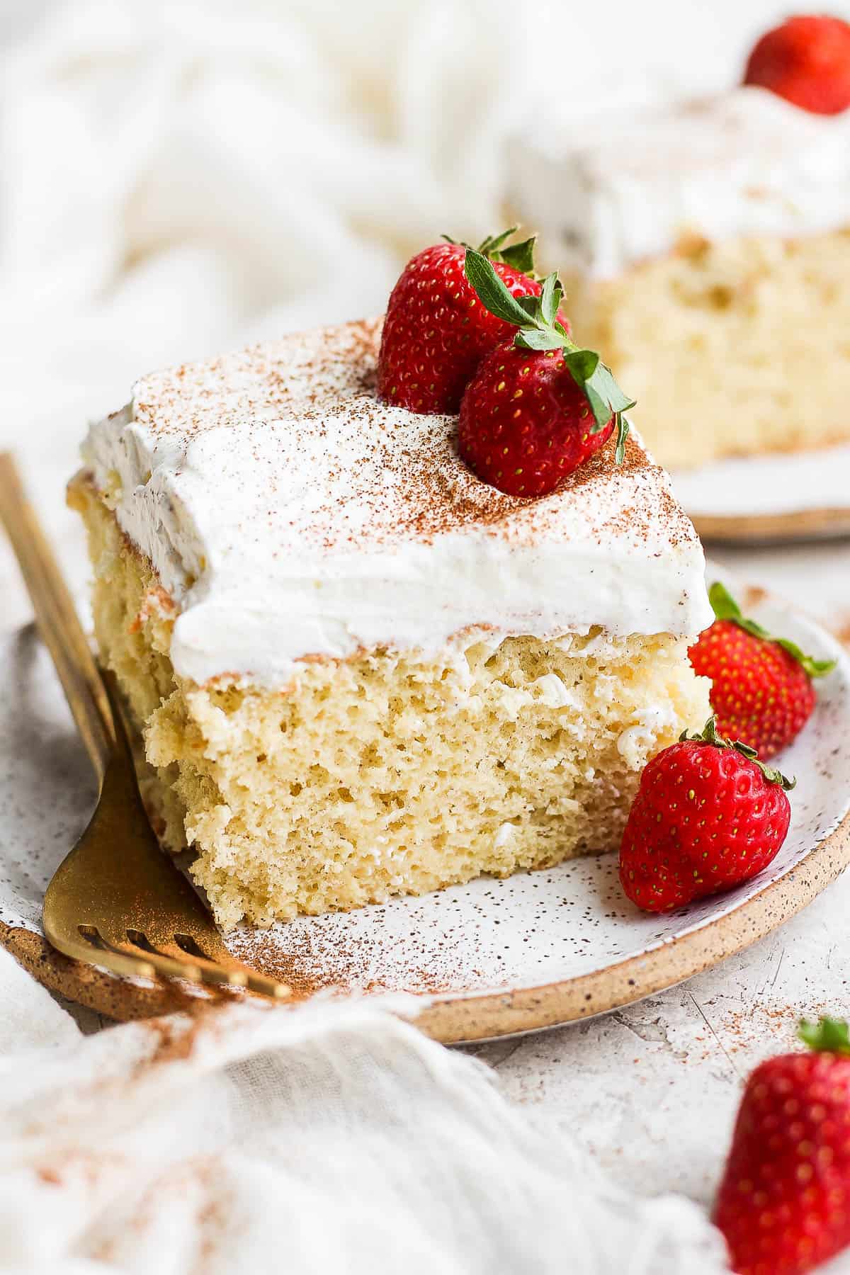 A slice of tres leches cake ready to eat.