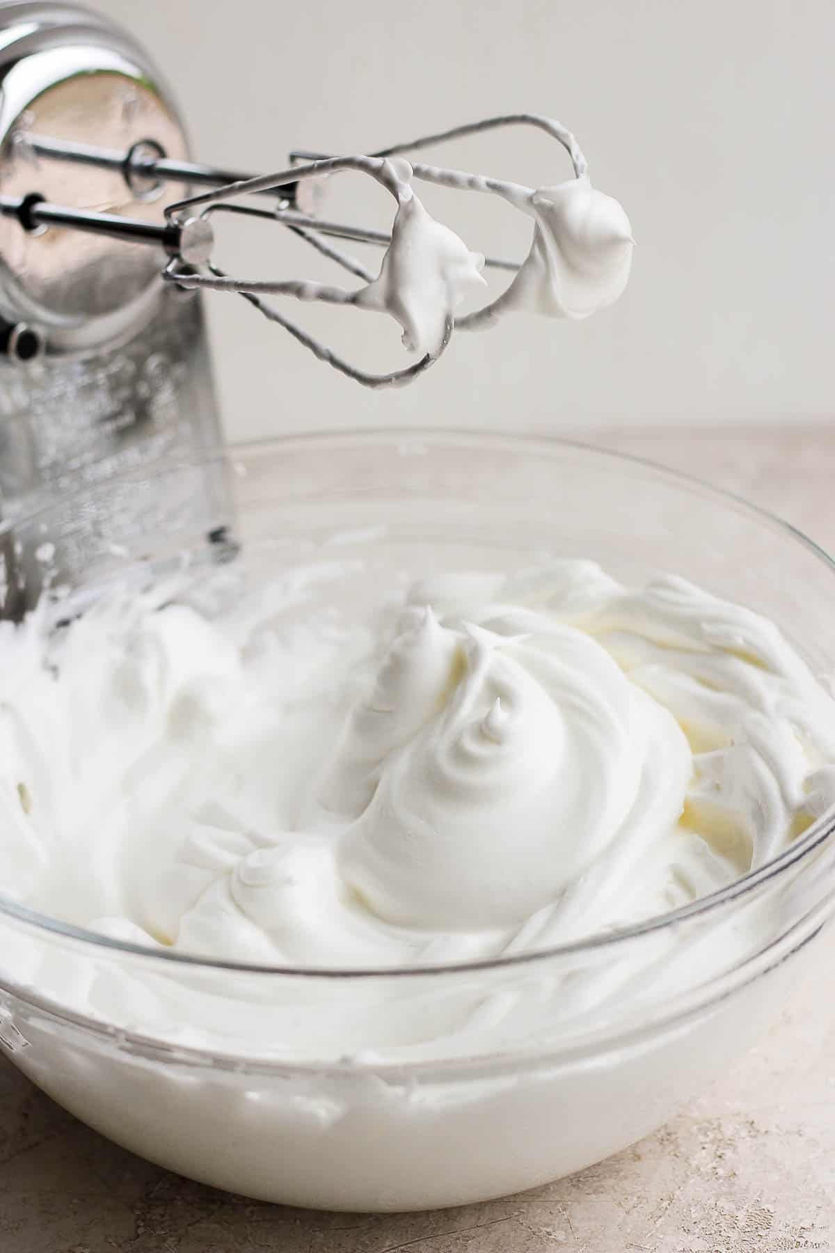 Whipped eggs whites in a bowl.