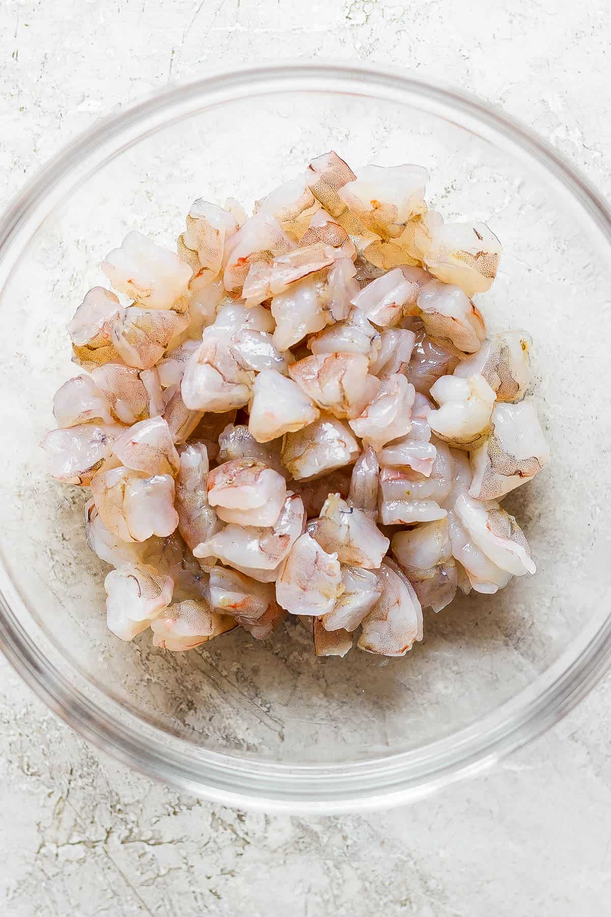 Bite-sized raw shrimp in a bowl for ceviche.