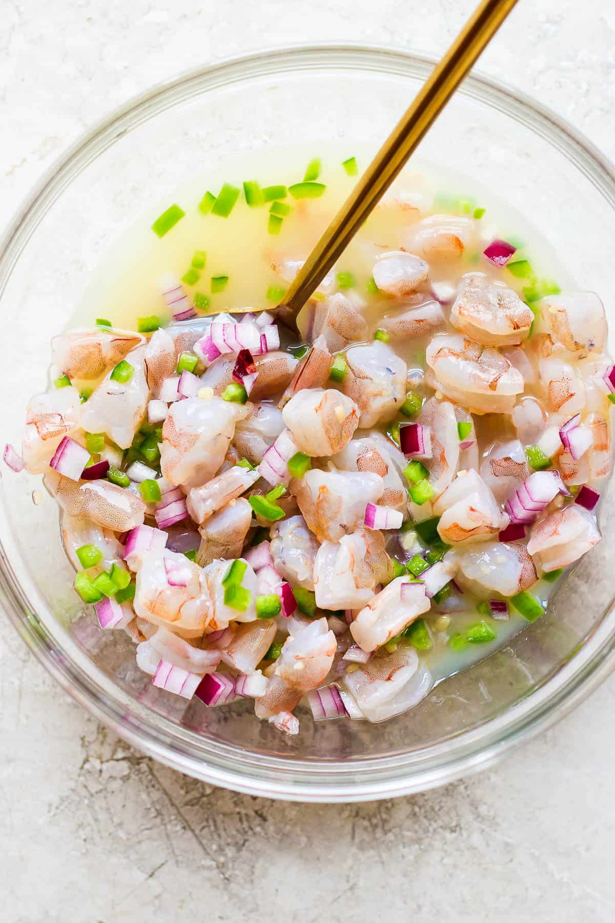 Ingredients for ceviche mixed together in a bowl.