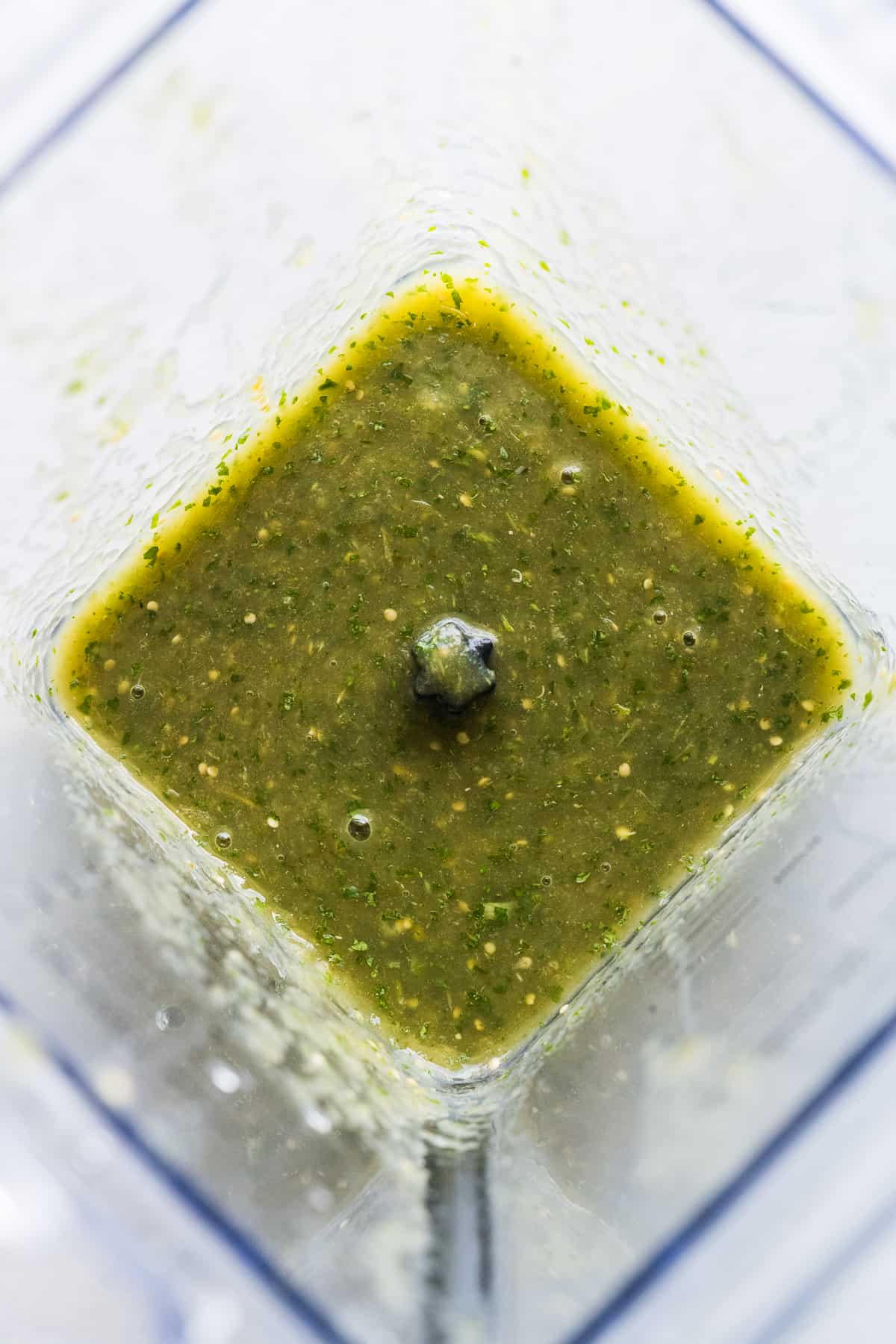 Salsa verde in a blender blended with some cilantro.