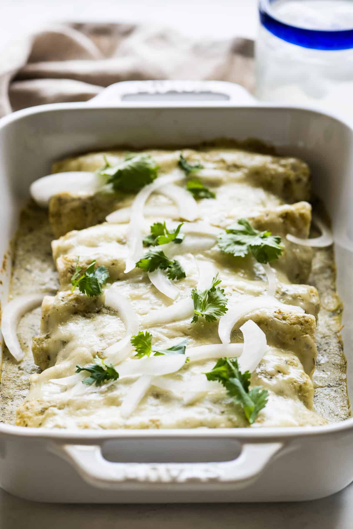 Enchiladas suizas in a baking dish ready to serve.