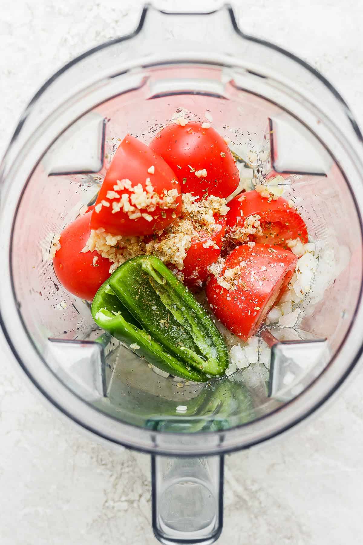 Tomatoes, onions, garlic, and jalapeños in a blender.