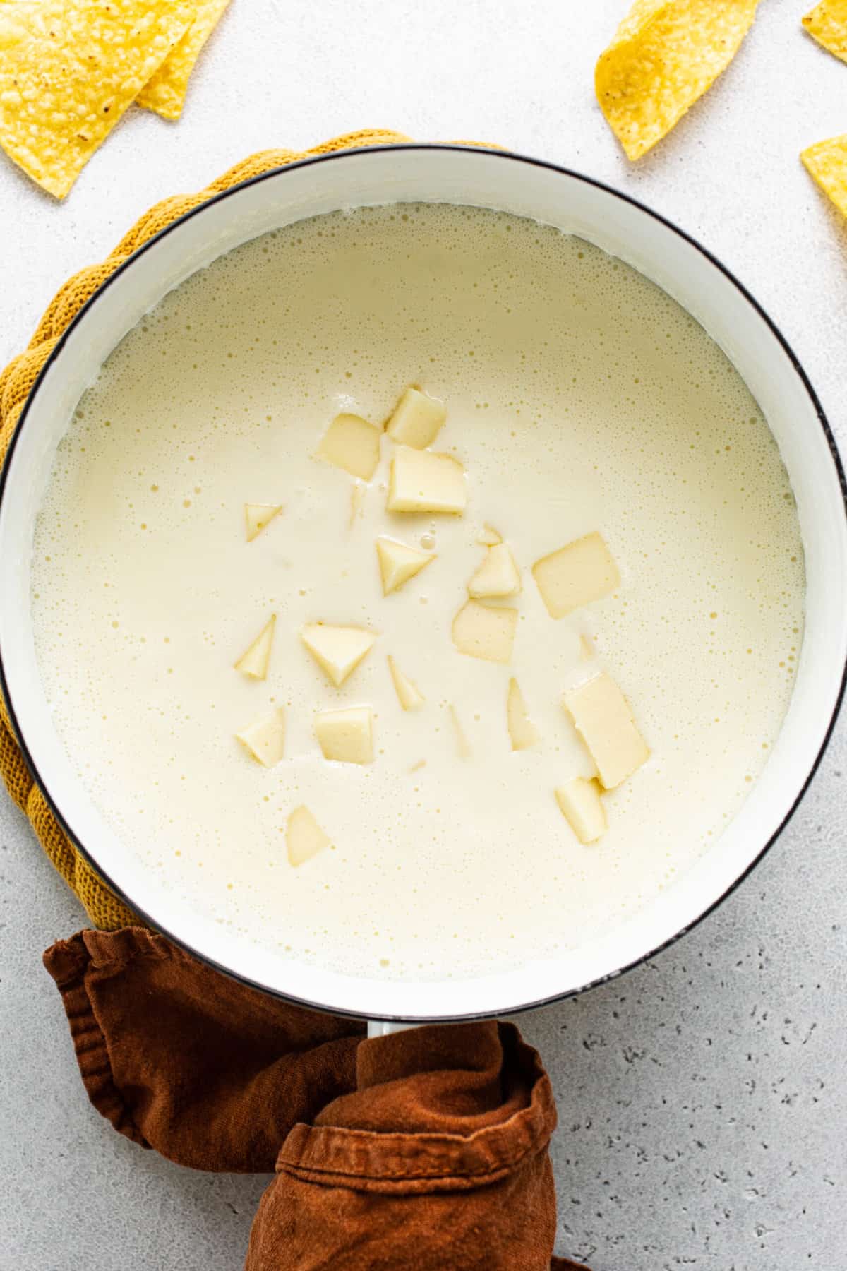 White American cheese in a pot being melted to make queso blanco