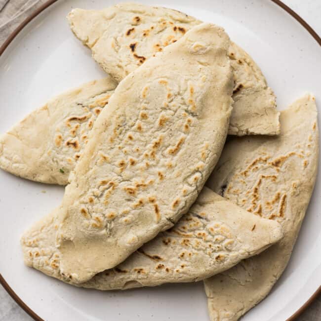 Tlacoyos filled with beans on a plate.