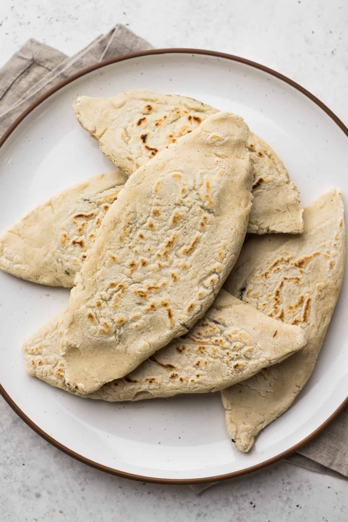 Tlacoyos filled with beans on a plate.