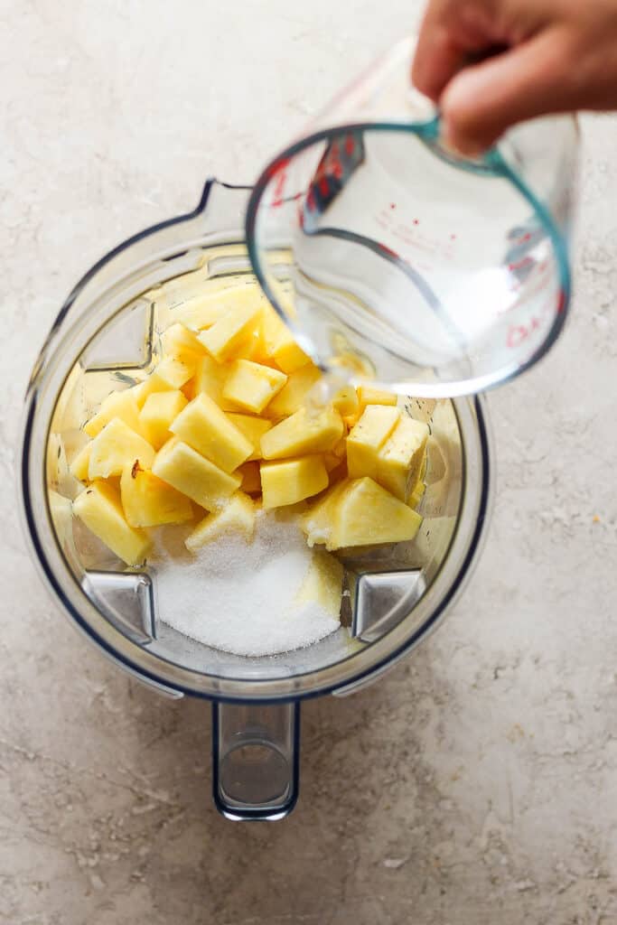Pineapple, water, and sugar in a blender.