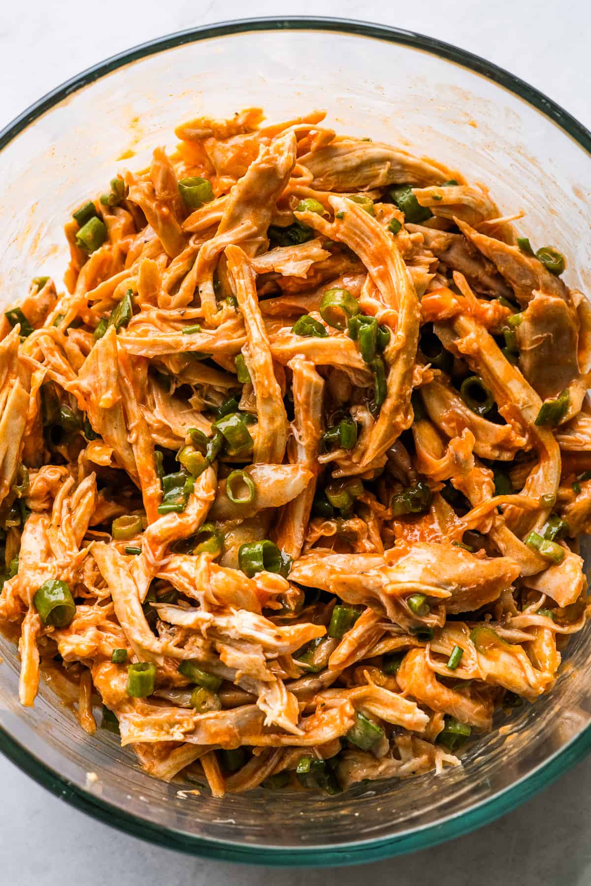 Buffalo chicken enchilada filling ingredients in a bowl.