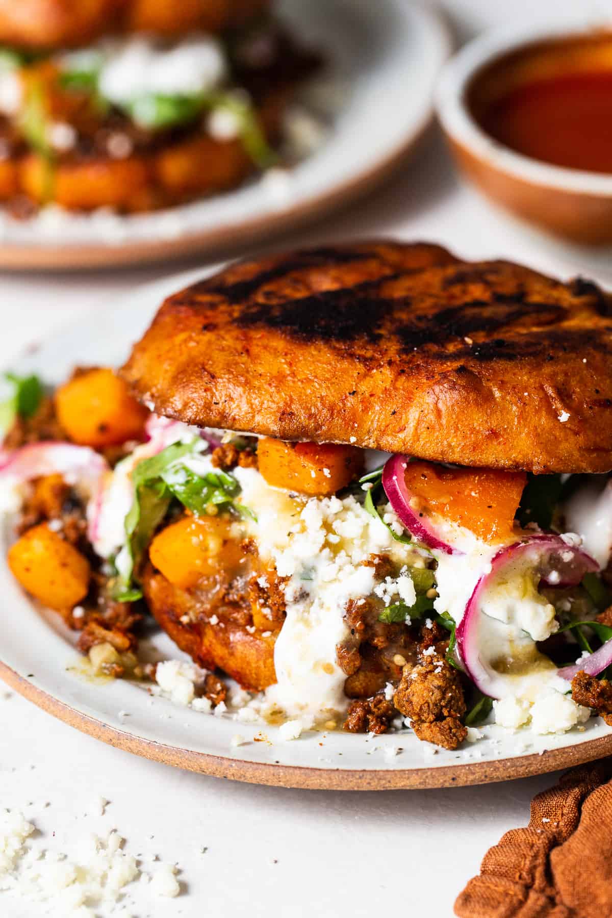 Pambazos on a plate with a potato and chorizo filling spilling out.