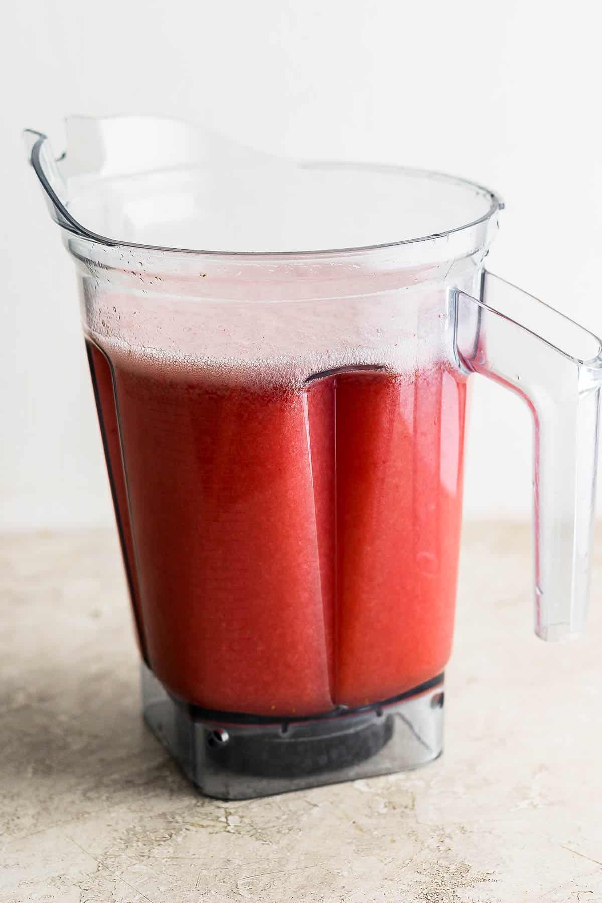 Blended agua de fresa (strawberry agua fresca) in a blender.