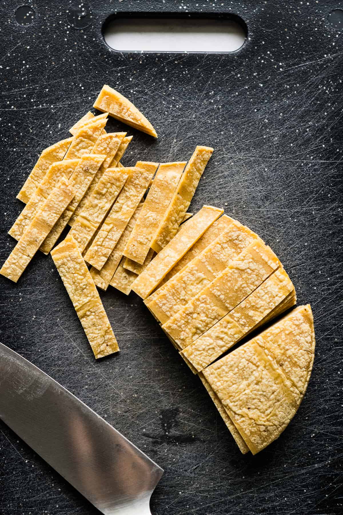 Corn tortillas sliced into 1/2-inch strips.