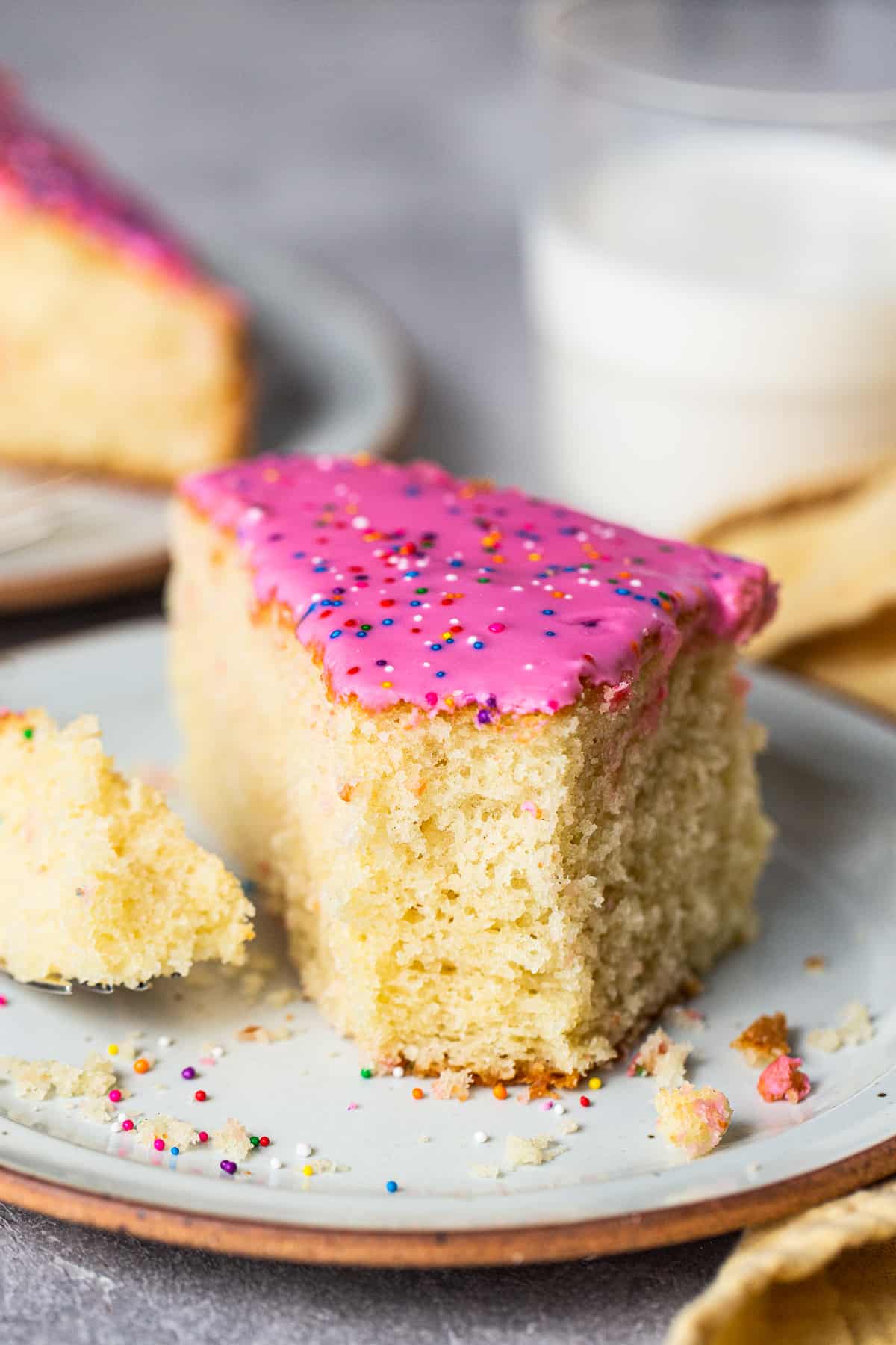 A slice of fluffy cortadillo bread on a plate with a bite taken out.